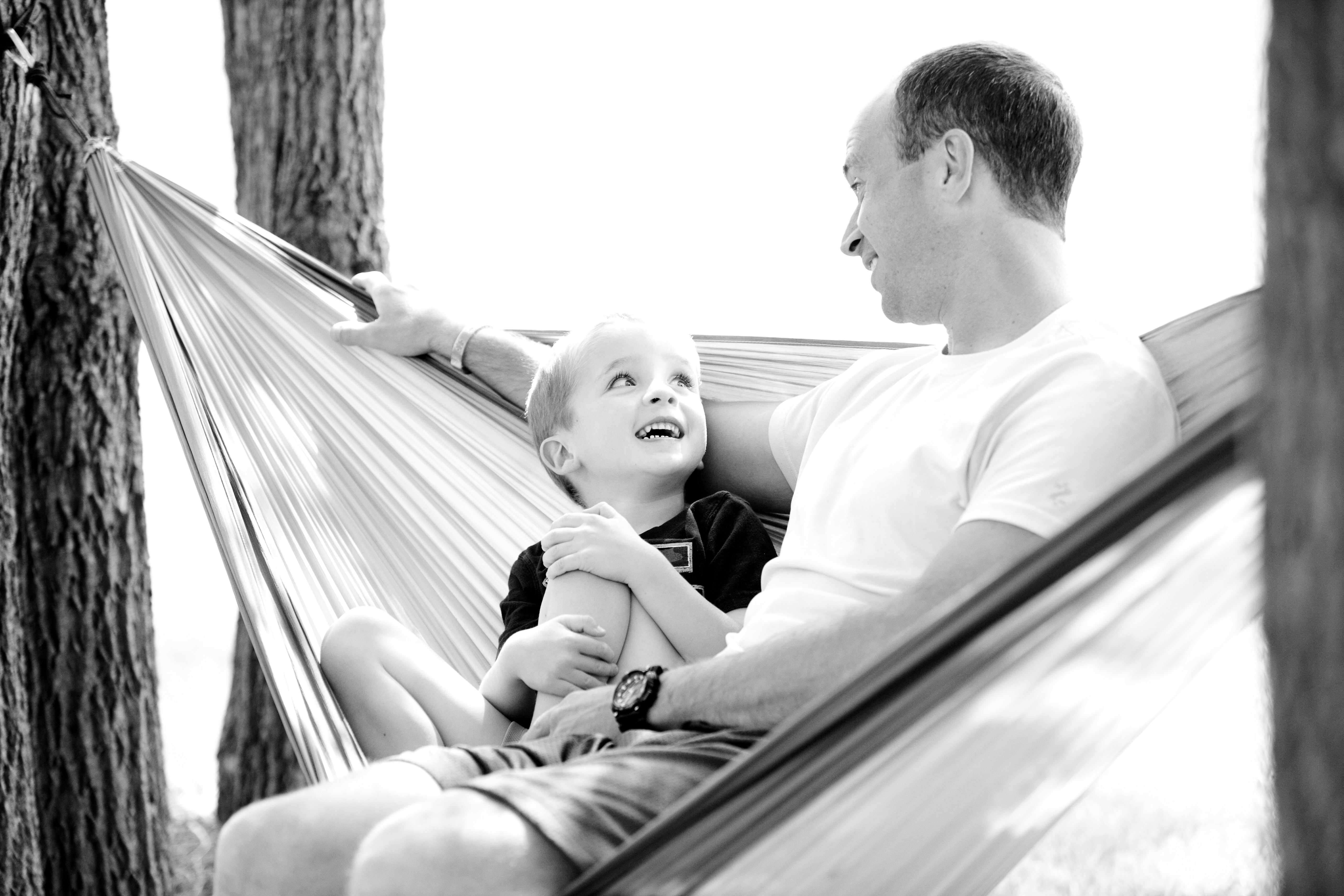 Vader en zoon tijdens een intiem moment in een hangmat